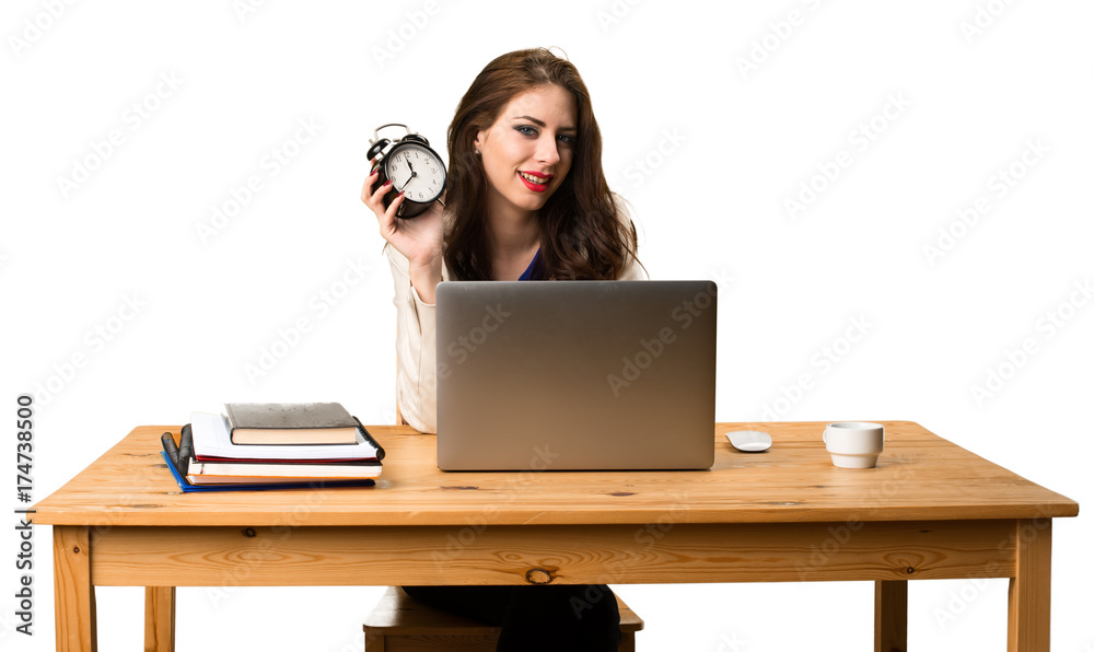 Business woman working with her laptop and holding vintage clock Business woman working with her laptop and holding vintage clock