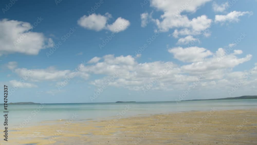 An upward movement of the shot to show the beauty of the beach and the sky. An upward movement of the shot to show the beauty of the beach and the sky.