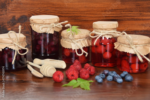 blueberries and raspberries in jars for the winter tea © Kinga