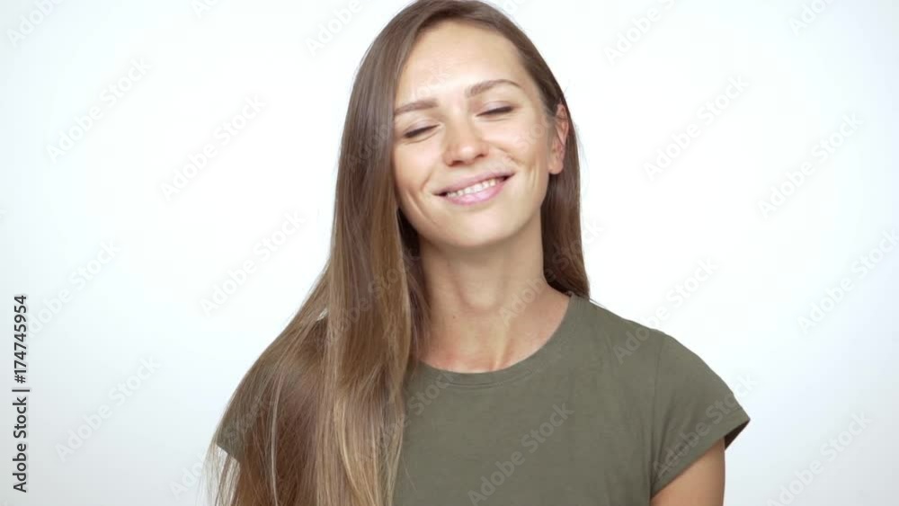 portrait of pretty caucasian female wearing braces with long brown hair looking at camera and smiling closeup slowmotion. Concept of emotions portrait of pretty caucasian female wearing braces with long brown hair looking at camera and smiling closeup slowmotion. Concept of emotions