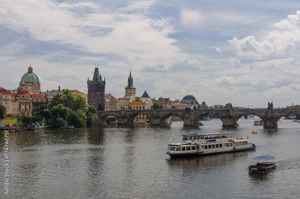 Cityscape view on the riverside with the bridge and old town in Prague