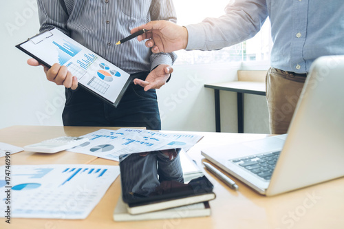 Co working conference, Business team meeting present, investor colleagues discussing new plan financial graph data on office table with laptop and digital tablet, Finance, accounting, investment photo