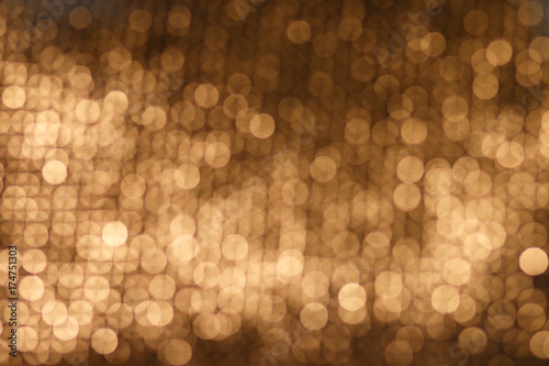 Abstract golden background. Abstract golden bokeh background, festive theme. Golden abstract sparkles or glitter lights. Festive gold background. Defocused circles bokeh or particles. Template for des