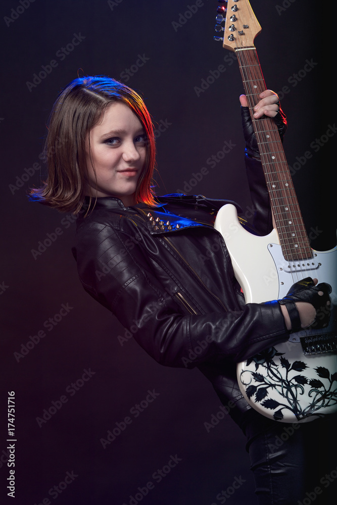 Fototapeta premium Young attractive rock girl playing the electric guitar