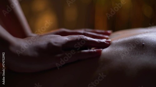 massage of the female back. hands of the masseuse, foot massage