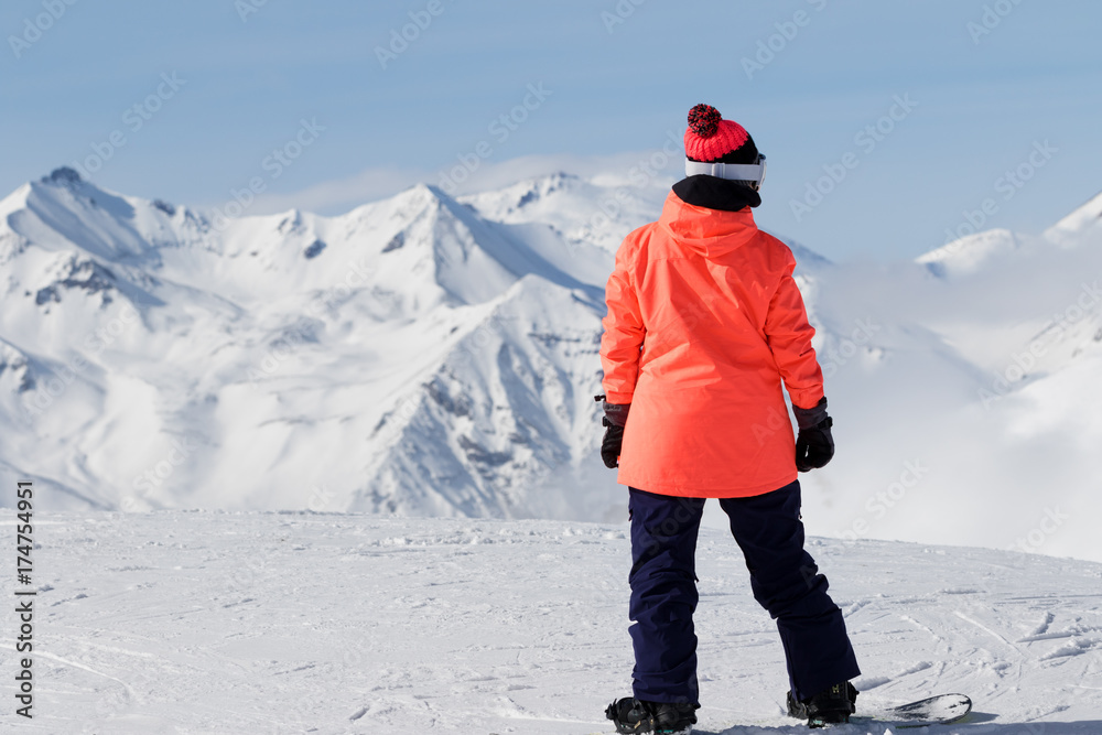 Snowboarder on top of mountain before downhill