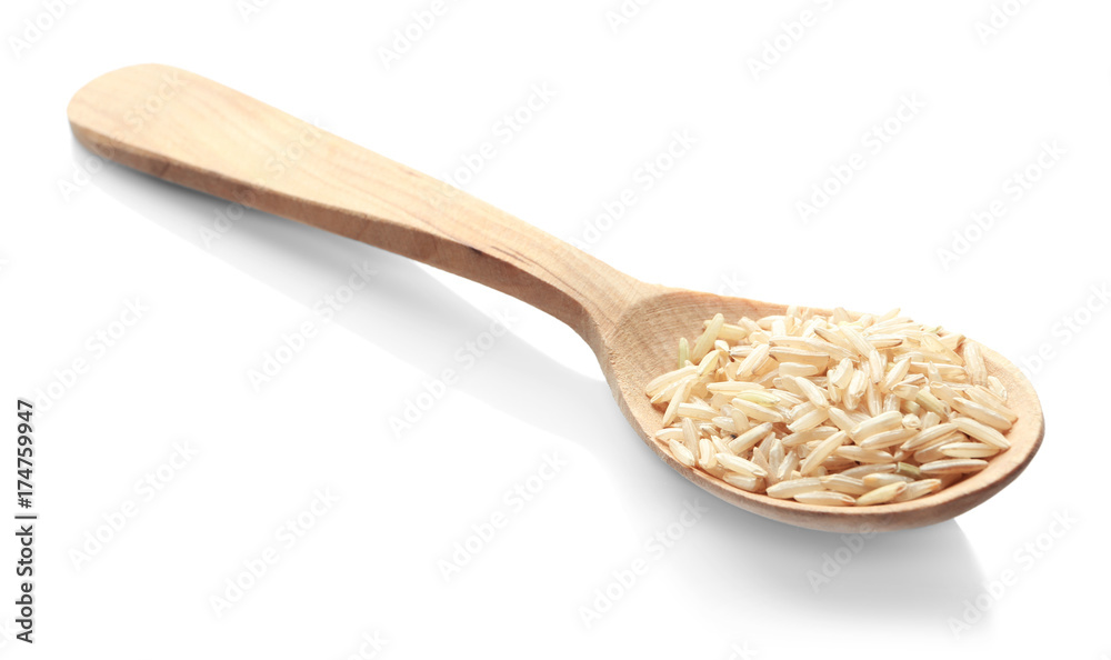 Wooden spoon with brown rice on white background Wooden spoon with brown rice on white background
