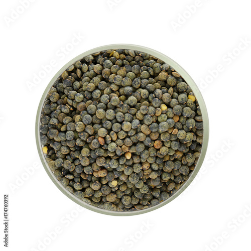 Glass jar with french green lentils on white background