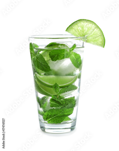 Cold fresh mojito with mint and lime slices in glass on white background
