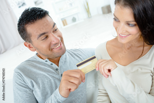 couple buying online on the internt with credit card photo