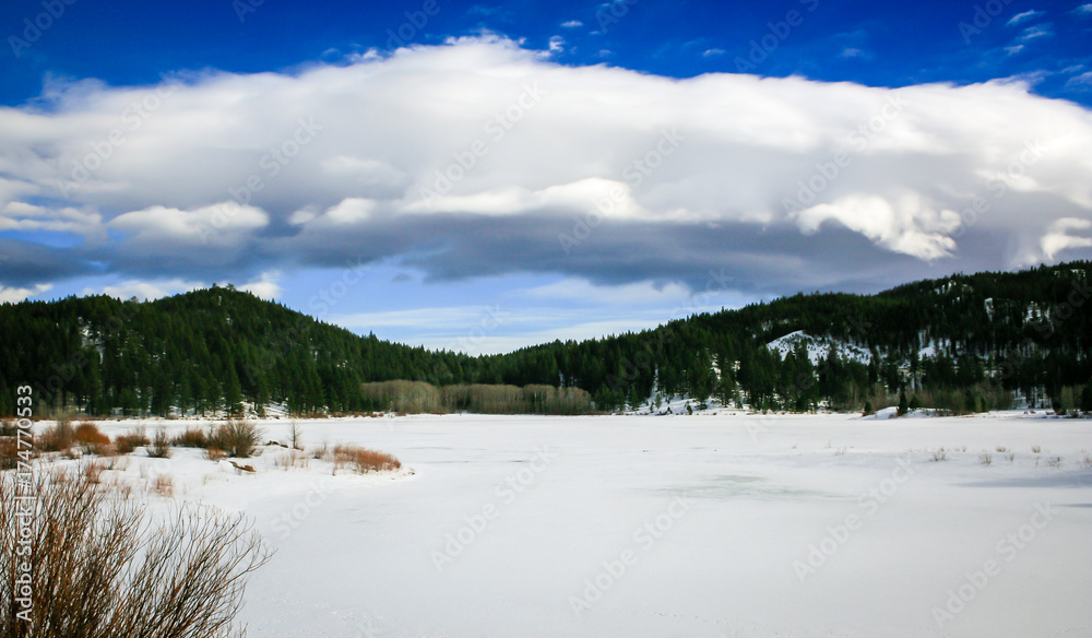Snow covered frozen mountain lake