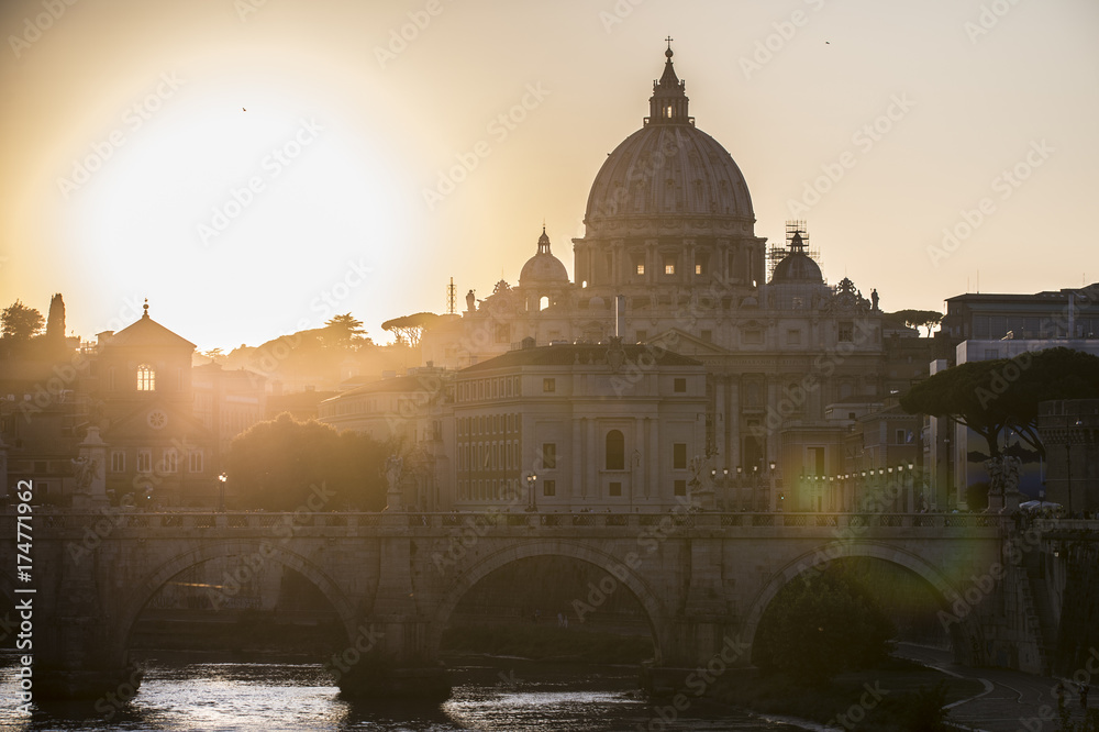 Obraz premium Rome, Italy.Vatican dome of Saint Peter Basilica (San Pietro) and Sant'Angelo Bridge, over Tiber river at sunset. One of the most famous view in the World. One of the most famous view in the World