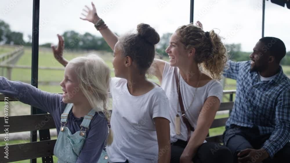  Families visiting rural activity centre looking out at sights on tractor ride