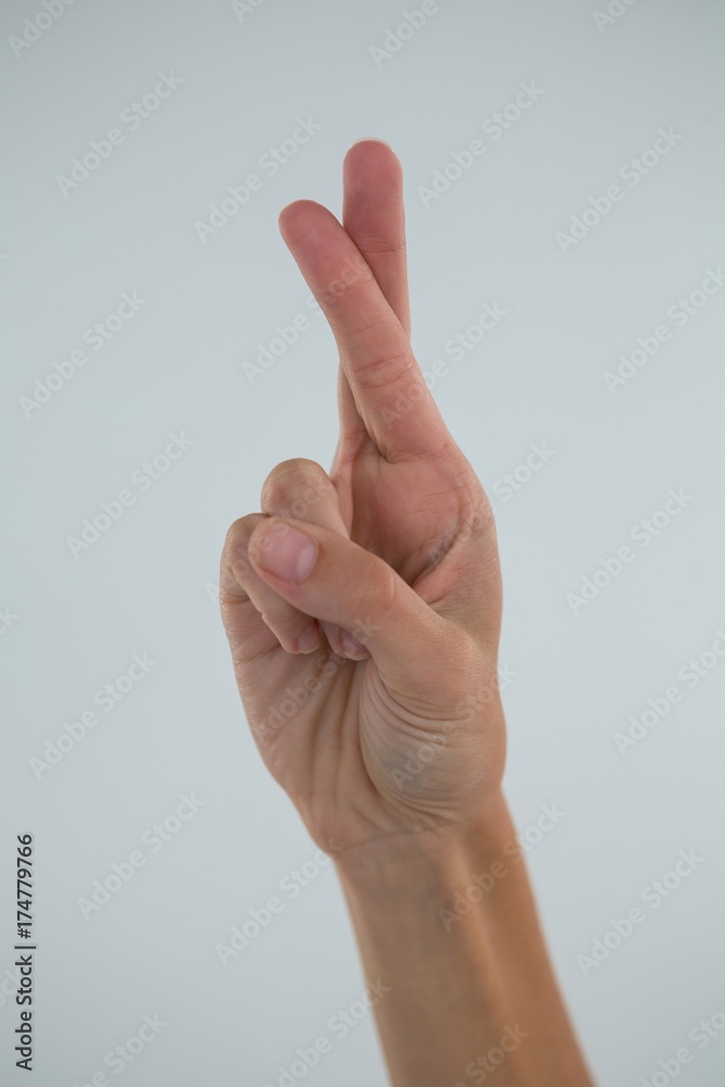Cropped hand showing crossed fingers Cropped hand showing crossed fingers