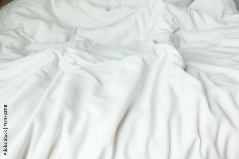 Obraz premium Top view of white bedding sheets after wake up in the morning