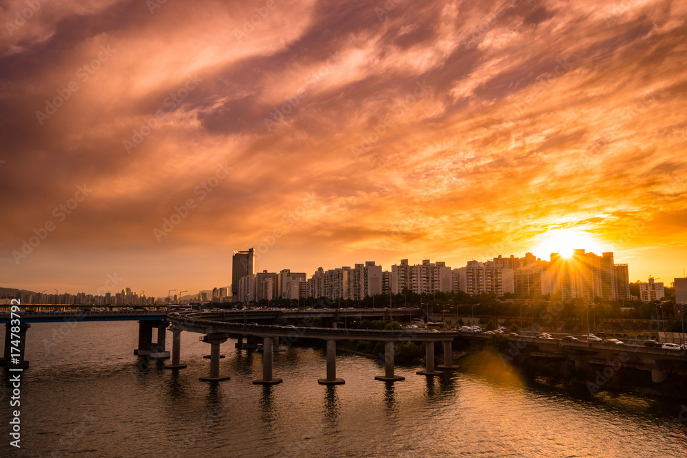Sunset landscape between Hangang road and apartments where the intersection of Seoul and South Korea is visible.