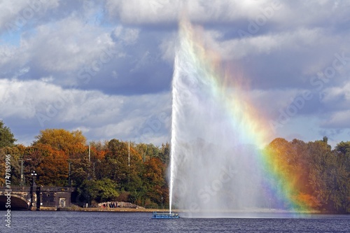 Alster fountain  water fountain with a rainbow on the Inner Alster lake in the center of the Hanseatic city of Hamburg  Germany  Europe