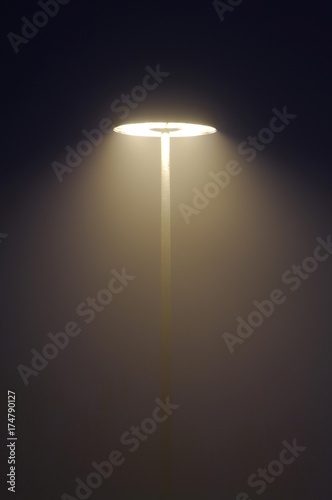 Street lights in the fog at night