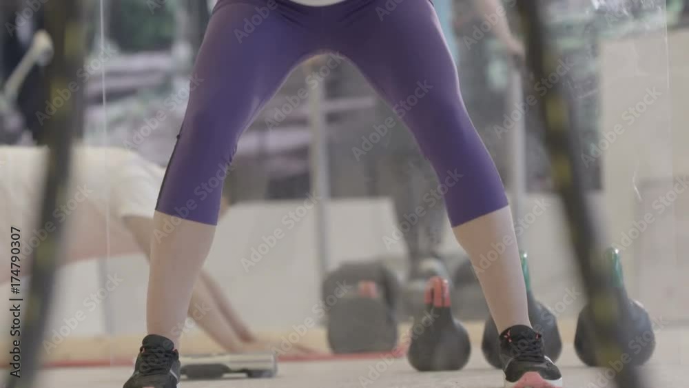 Attractive young fit woman strength training with ropes at the gym Attractive young fit woman strength training with ropes at the gym