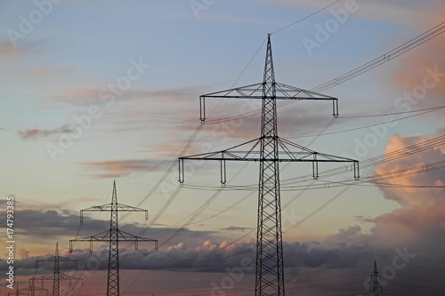 Transmission towers or electricity pylons, evening mood, cloudy sky, Baden-Wuerttemberg, Germany, Europe