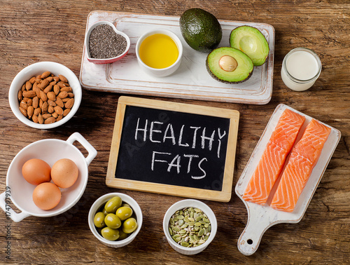 Selection of healthy fat sources on wooden background photo