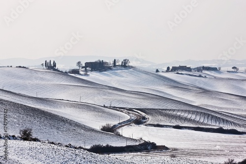 Farmhouse on a snow-covered hill near Monteroni d'Arbia, Tuscany, Italy, Europe photo