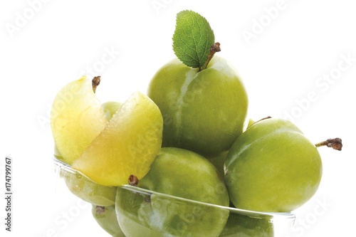 Greengages (Prunus italica) with small leaves in a glass