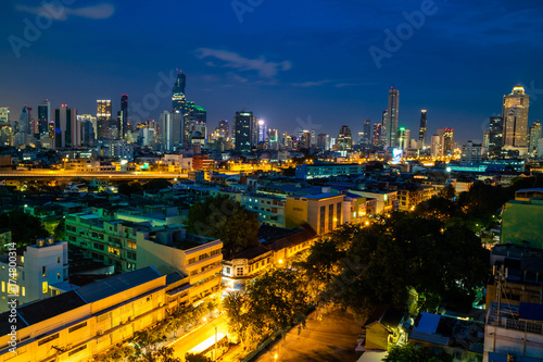 Bangkok cityscape skyline, Thailand. Modern tower and local building, express way, road and vehicle,  and train station at twilight evening
