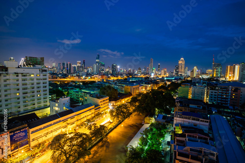 Bangkok cityscape skyline, Thailand. Modern tower and local building, express way, road and vehicle, and train station at twilight evening