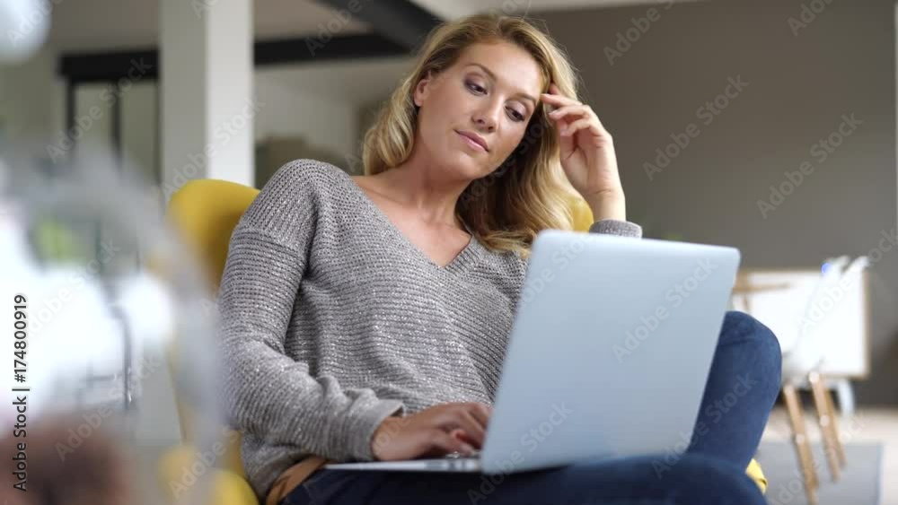 Woman at home connected on laptop computer Woman at home connected on laptop computer