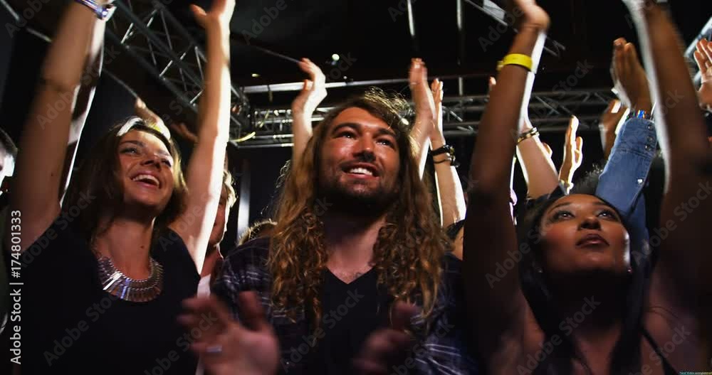 Group of people dancing at a concert 