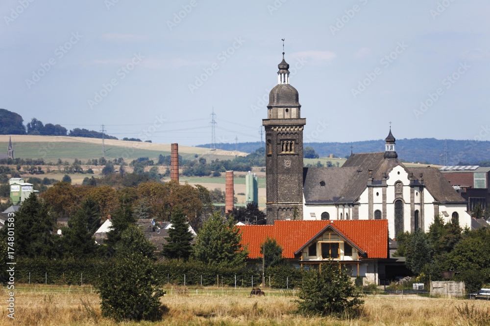 Longshot of the parish church St. Dionysius in Kruft, Mayen-Koblenz, Rhineland-Palatinate, Germany, Europe Longshot of the parish church St. Dionysius in Kruft, Mayen-Koblenz, Rhineland-Palatinate, Germany, Europe