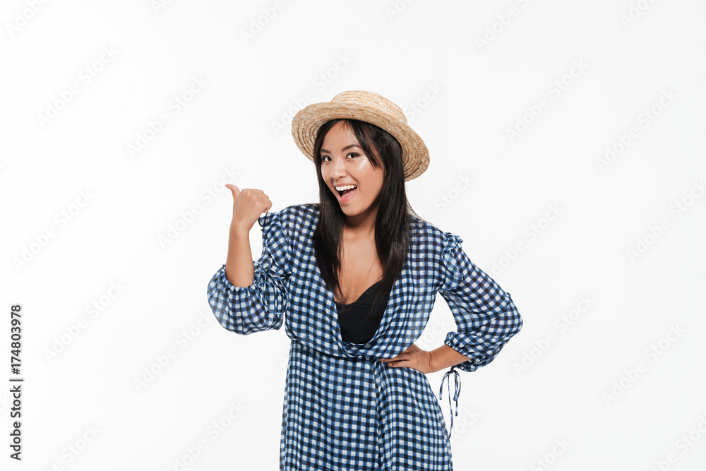 Portrait of an attractive asian woman in dress and hat Portrait of an attractive asian woman in dress and hat