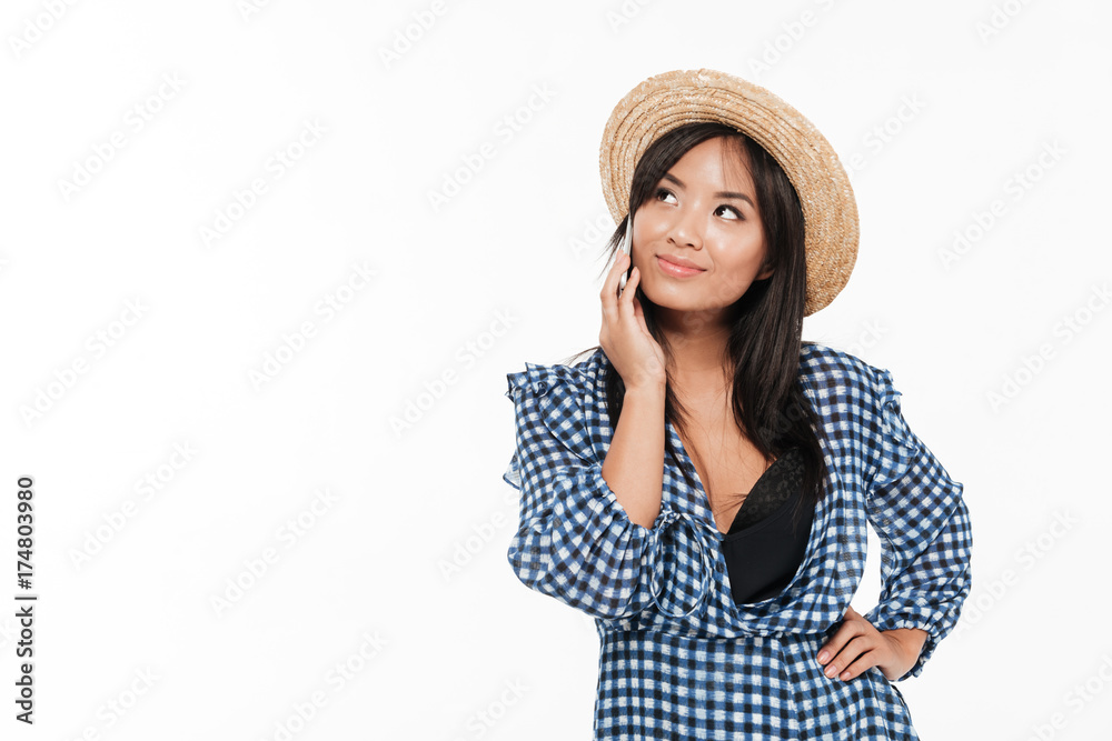 Portrait of a smiling asian woman in dress and hat Portrait of a smiling asian woman in dress and hat