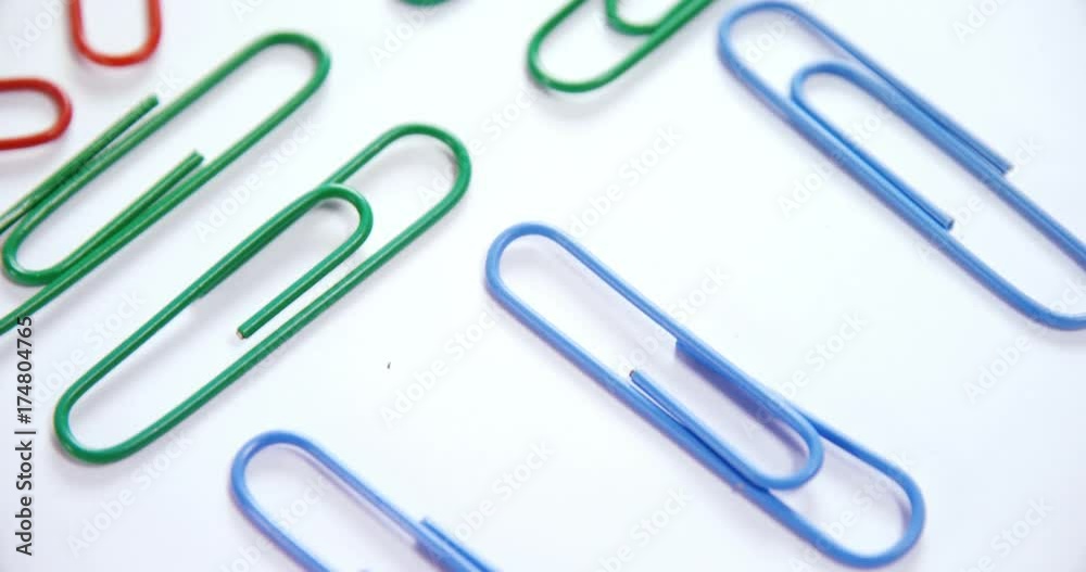 Colorful paper clips arranged on white background Colorful paper clips arranged on white background