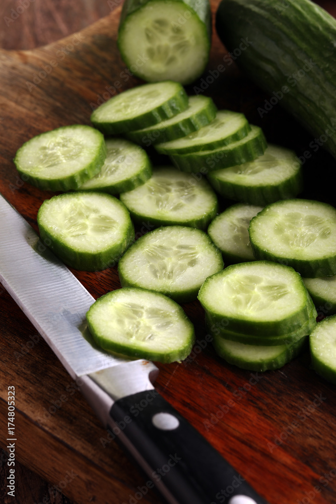 Fresh and sliced cucumbers. Sliced cucumbers on a cutting board. Fresh and sliced cucumbers. Sliced cucumbers on a cutting board.
