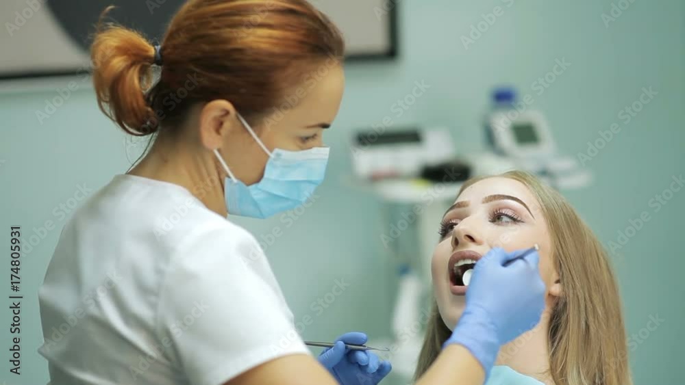 Dentist examining a patient's teeth in the dentistry Dentist examining a patient's teeth in the dentistry