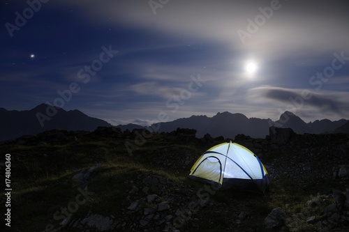 Fototapeta Naklejka Na Ścianę i Meble -  Bivouac tent with a full moon and mountain range, Hinterhornbach, Lechtal, Ausserfern, Tyrol, Austria, Europe