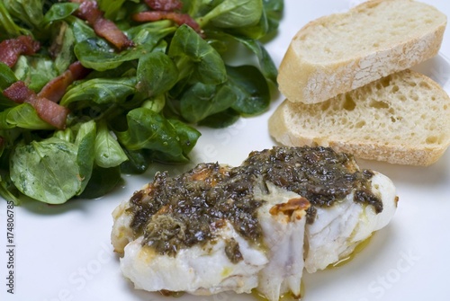 Sea-Devil fish (Lophius piscatorius) with with algae tartar and field salad (Valerianella locusta) with roasted bacon strips and baguette bread photo