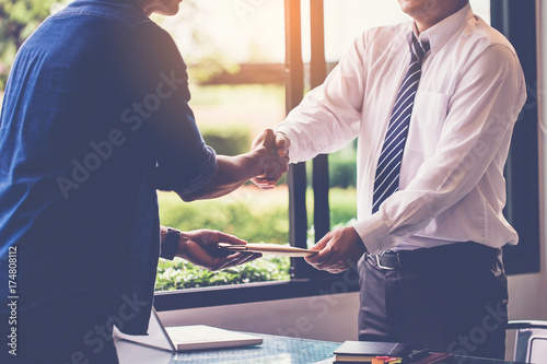 businessman shaking hand after recieve document from delivery man