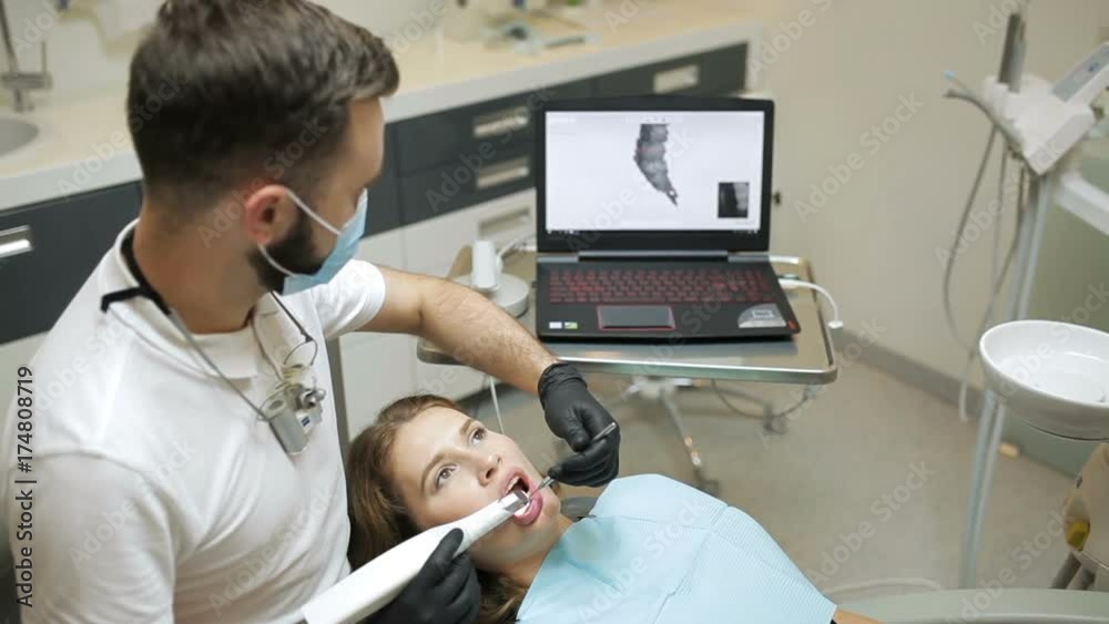 Dentist scanning the teeth of patient with a d scanner