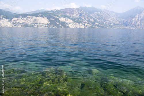 Pure clear waters on the shore of the lake Lago Di Garda, Malcesine, Italy