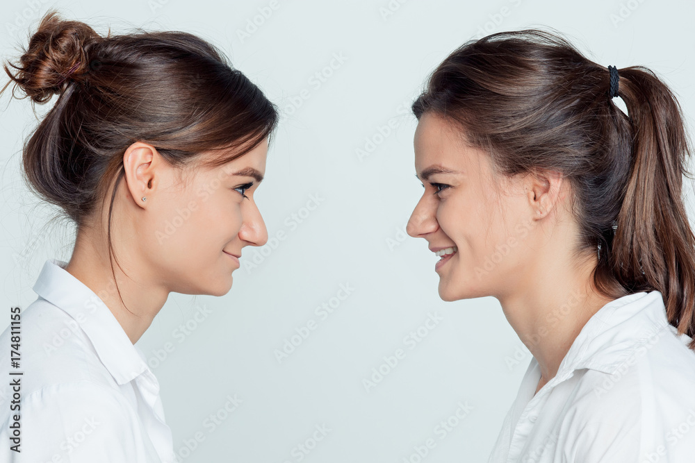 Studio portrait of female twins Studio portrait of female twins