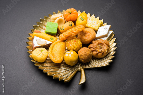 Sticker stock photo of Indian sweet or mithai and oil lamp or diya with gift box and flo