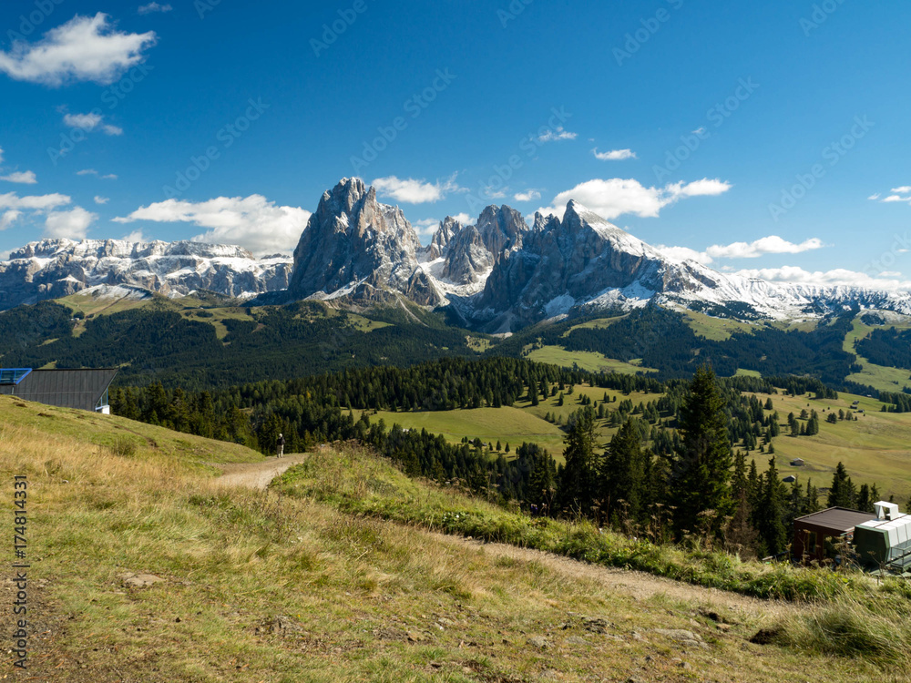 Summer over gree mountains in Italy, Dolomites Alps. Green grass, blue sky and mountains