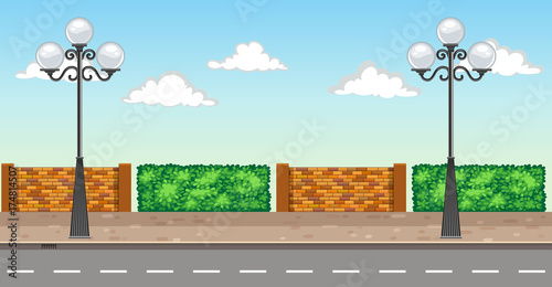 Scene with two lampposts on pavement