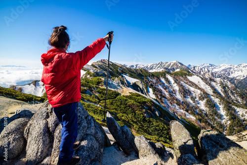 Wallpaper Mural Successful woman at top of Mount Tsubakuro Dake, famous trekking mountain in Azumino, Nagano, Japan. It is situated in Japan's Hida Mountains or Japan Alps. Torontodigital.ca