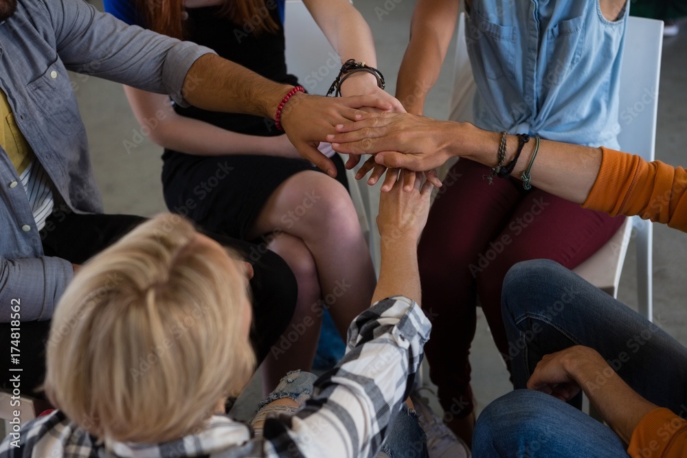 High angle view of friends stacking hands