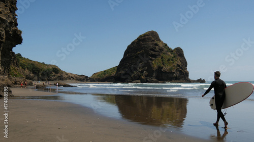 Photography Surfer walks at Piha Beach