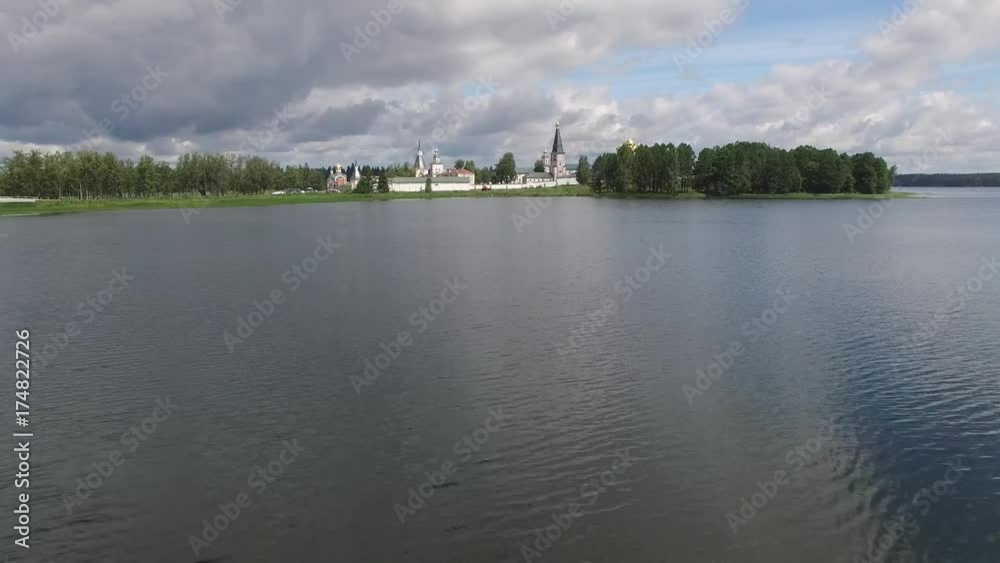 Reflections Valday Iversky Russian Orthodox Monastery. Valdaysky National Park UNESCO Biosphere Reserve Lake Seliger. Flight low to water aerial drone. Beautiful nature summer clouds horizon. Reflections Valday Iversky Russian Orthodox Monastery. Valdaysky National Park UNESCO Biosphere Reserve Lake Seliger. Flight low to water aerial drone. Beautiful nature summer clouds horizon.